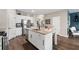 Modern kitchen with a center island, white cabinets, granite countertops, and stainless steel appliances at 2169 Lanier Harbor Pt, Buford, GA 30518