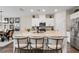 Modern kitchen featuring white cabinets, stainless steel appliances, and an island with seating at 2169 Lanier Harbor Pt, Buford, GA 30518