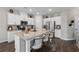 Spacious kitchen with a large island featuring bar seating, granite countertops, white cabinets, and stainless steel appliances at 2169 Lanier Harbor Pt, Buford, GA 30518