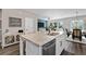 Bright kitchen featuring a large island with granite countertops and stainless steel appliances at 2169 Lanier Harbor Pt, Buford, GA 30518