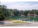 Beautiful view of a lake with a boat launch and dock, surrounded by trees and parking at 2169 Lanier Harbor Pt, Buford, GA 30518