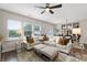Comfortable living area with sectional sofa, ottomans, and views of the dining area at 2169 Lanier Harbor Pt, Buford, GA 30518