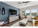 Cozy living room with plush sectional sofa, stylish ottomans, and ceiling fan at 2169 Lanier Harbor Pt, Buford, GA 30518