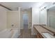 Spacious bathroom with soaking tub, shower, granite countertop, and walk-in closet at 2189 Executive Dr, Duluth, GA 30096