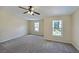 Large bedroom with two windows offering natural light and neutral carpet at 2189 Executive Dr, Duluth, GA 30096