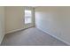 Neutral bedroom with large window, light walls and plush carpet at 2189 Executive Dr, Duluth, GA 30096