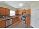 The kitchen features stainless appliances, lots of counter space, wood cabinets, and tile backsplash at 2189 Executive Dr, Duluth, GA 30096