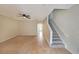Spacious living room featuring neutral walls, tile floors, ceiling fan, and stairway at 2189 Executive Dr, Duluth, GA 30096