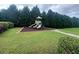 A neighborhood playground with slides and climbing area surrounded by dense trees at 2189 Executive Dr, Duluth, GA 30096