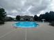 A community swimming pool and clubhouse on a cloudy day, with ladder steps into pool at 2189 Executive Dr, Duluth, GA 30096