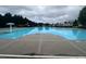 Outdoor pool with a clear blue water surrounded by trees and buildings on a cloudy day at 2189 Executive Dr, Duluth, GA 30096