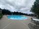 A community swimming pool with wading fountain, surrounded by mature trees and lounge seating at 2189 Executive Dr, Duluth, GA 30096