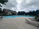 A community swimming pool with wading fountain and steps, surrounded by lounge seating and clubhouse at 2189 Executive Dr, Duluth, GA 30096
