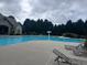 A community swimming pool with wading fountain and steps, surrounded by lounge seating and clubhouse at 2189 Executive Dr, Duluth, GA 30096