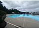 Large community pool surrounded by lush trees, perfect for relaxation and recreation at 2189 Executive Dr, Duluth, GA 30096