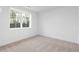 Inviting bedroom with neutral carpet and a window providing natural light and suburban views at 628 Skytop Dr # 158, Cumming, GA 30040