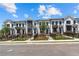 New construction townhomes with white siding, black trim, wrought iron fences and professional landscaping at 628 Skytop Dr # 158, Cumming, GA 30040