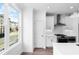 Bright kitchen features white cabinets, stainless steel appliances, subway tile backsplash, and a large window at 628 Skytop Dr # 158, Cumming, GA 30040