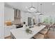 Modern kitchen features stainless steel appliances, a center island with seating, and a view of the living area at 628 Skytop Dr # 158, Cumming, GA 30040