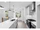 Modern kitchen with stainless steel appliances, large island with sink, and pendant lighting at 628 Skytop Dr # 158, Cumming, GA 30040