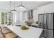 Bright, modern kitchen featuring a white quartz countertop island with seating and stainless steel appliances at 628 Skytop Dr # 158, Cumming, GA 30040