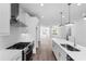 Bright kitchen features an island, stainless appliances and connects seamlessly to the open living space at 628 Skytop Dr # 158, Cumming, GA 30040