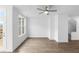 Bright living room features hardwood floors, a ceiling fan, and a door leading to an outdoor space at 628 Skytop Dr # 158, Cumming, GA 30040