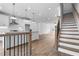 Open-concept living space with hardwood floors, staircase, and a view into the modern kitchen at 628 Skytop Dr # 158, Cumming, GA 30040