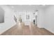 Spacious living room with hardwood floors that connects to kitchen with island and staircase at 628 Skytop Dr # 158, Cumming, GA 30040