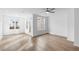 Sunlit living room with hardwood floors, a ceiling fan, and large windows offering neighborhood views at 628 Skytop Dr # 158, Cumming, GA 30040