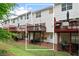 Townhome exterior featuring multiple decks, a patio, and a lawn at 651 Coligny Ct, Atlanta, GA 30350