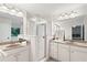 Bathroom with double sinks, granite countertops, and glass shower at 651 Coligny Ct, Atlanta, GA 30350