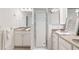 Neutral bathroom with granite vanities, a glass enclosed shower, and neutral tile flooring at 651 Coligny Ct, Atlanta, GA 30350