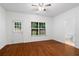 Bedroom with wood flooring, large windows, and a view to a bathroom at 651 Coligny Ct, Atlanta, GA 30350