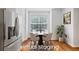 Bright breakfast nook with a stainless steel refrigerator and hardwood floors at 651 Coligny Ct, Atlanta, GA 30350