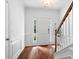 Bright home entryway with hardwood floors, staircase, and a view through the front door at 651 Coligny Ct, Atlanta, GA 30350