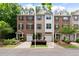 Charming brick townhome with a well-manicured front yard and an attached garage at 651 Coligny Ct, Atlanta, GA 30350