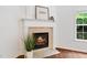 Cozy fireplace with white mantel, perfect for relaxing on a chilly evening at 651 Coligny Ct, Atlanta, GA 30350