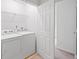 Functional laundry room with appliances, wire shelving and access to other rooms at 651 Coligny Ct, Atlanta, GA 30350