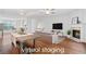 Bright, open living room with hardwood floors, fireplace, and ample natural light at 651 Coligny Ct, Atlanta, GA 30350