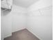 Walk-in closet with white walls, neutral carpet, and wire shelving at 651 Coligny Ct, Atlanta, GA 30350