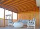 Relaxing back porch featuring wood floors and walls, comfortable seating, and a beautiful pergola at 303 Latimer Se St, Marietta, GA 30008