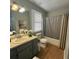 Bathroom featuring a single-sink vanity, wood-look flooring, neutral paint, and ample storage at 303 Latimer Se St, Marietta, GA 30008