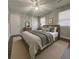 Bright bedroom featuring a ceiling fan, hardwood floors, neutral walls, and a plush bed at 303 Latimer Se St, Marietta, GA 30008
