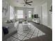 Cozy living room featuring dark hardwood flooring, white walls, a ceiling fan, and plenty of natural light at 303 Latimer Se St, Marietta, GA 30008