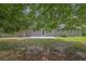 The backyard includes a lush lawn, mature trees and a patio, providing a peaceful outdoor retreat at 3181 Woodbridge Ct, Snellville, GA 30039