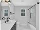 Modern bathroom features black fixtures, white tile, and a glass enclosed shower at 3181 Woodbridge Ct, Snellville, GA 30039