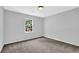 Bright, carpeted bedroom with neutral paint and a large window at 3181 Woodbridge Ct, Snellville, GA 30039