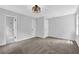 This bedroom features neutral paint, carpet flooring, a light fixture, bathroom access and closet for comfortable living at 3181 Woodbridge Ct, Snellville, GA 30039