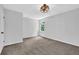 This cozy bedroom has a window, plush carpet flooring and a light fixture for relaxed and comfortable living at 3181 Woodbridge Ct, Snellville, GA 30039